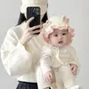 Gorro de bebé otoño e invierno dulce lazo protección para las orejas tejido sombrero de princesa niña cálido a prueba de viento sombrero de lana moda