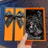Vehículo de construcción de aleación caricatura creativa mini mochila colgante de llavero clip de regalo muñeco máquina juguete especial venta al por mayor