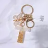 Fornecedor da Fábrica Chaveiros de Metal Dourado com Pedras e Borlas de Borboleta, Pingentes de Chave e Charms para Bolsas Femininas