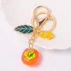 Llavero Creativo con Diseño de Caqui de la Suerte y Cacahuete, Colgante Pequeño con Pedrería, Llavero de Fruta Caqui de Metal al por Mayor