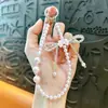Cadena para Teléfono Colgante de Cristal con Moño y Trébol de Cuatro Hojas Accesorios para Bolsos Llavero de Regalo Venta al por Mayor de Comercio Exterior