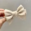 Grampo de cabelo de laço perolado doce feminino simples e elegante, presilha de cabeça de almôndega, 2023, novo estilo de celebridade da Internet, acessórios de cabeça
