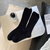 Calcetines de felpa con etiqueta en el talón para niños, primavera y otoño, viento frío, nicho, ins, moda, color liso, versátil, negro, tubo largo, calcetines de moda