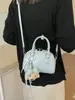 Bolso pequeño de estilo fresco transfronterizo para mujer, nuevo modelo 2026, bolso de hombro y cruzado para el trabajo, bolso tipo bowling moderno y a la moda para mujer