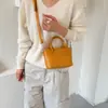 Bolso de mano moderno y sencillo, bolso tipo cubo texturizado, nuevo de la versión coreana para el verano de 2026, bolso de hombro simple y elegante, bolso cruzado
