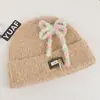 Gorro de punto estilo coreano de mezcla de lana inspirado en la dopamina con un lazo, un gorro de invierno cálido y protector para las orejas para mujer, adecuado para estudiantes