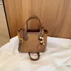 Moda transfronteriza simple y elegante estilo coreano diseño de nicho bolso de hombro cruzado casual, bolso de mano de color sólido moderno tipo cubo