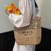 Bolsa tejida hueca súper popular de verano para mujer, nuevo estilo 2026, bolsa para vacaciones en la playa, bolsa de mano de paja de gran capacidad