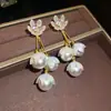 Pendientes de borla de flor de concha blanca transfronterizos europeos y americanos con perlas, pendientes de estilo de corte francés, pendientes ligeros y lujosos con un toque de alta gama