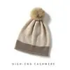 100% Cachemira Otoño/Invierno 2026 Nuevo Gorro de Punto para Mujer Casual Bloque de Color Pompón Borde Enrollado Cálido Protección para los Oídos Sombrero