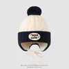 Venta al por mayor de gorros de punto para niños con pompón grande estilo coreano, cálidos y adecuados para el invierno 2026, para ventas transfronterizas