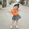 Conjunto de Verano para Niñas 2026 Nuevo Dulce Lazo Camiseta de Manga Corta y Falda Corta Floral Infantil Conjunto de Dos Piezas