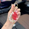 Llavero de arcilla de moda con signo de dólar incrustado de diamantes, cadena de perlas, colgante para bolso, colgante creativo de la fortuna, llavero
