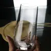 Vaso de vidrio de alta transparencia Jindalai para uso doméstico, vaso simple para agua, vaso para jugo, taza multifuncional para café, taza de lujo ligero estilo ins