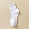 Medias clásicas en blanco y negro y gris para hombre y mujer, de color liso, con cintura antideslizante, de tubo medio, para deportes, informales, transpirables, de algodón.
