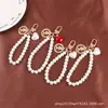 Nuevo Pulsera Creativa de Perlas, Llavero Colgante Lindo de Corazón de Melocotón de Aleación, Accesorio Metálico de Cabeza de Belleza, Bolso Decorativo para Mujer