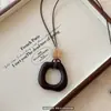 Nuevo colgante estilo chino collar largo irregular nuevo estilo para mujer sensación de alta gama accesorios de cadena para suéter de otoño e invierno diseño de nicho