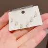 Conjunto de brincos de três peças estilo francês minimalista, formato gatinho, com pedra de trevo de quatro folhas, para mulheres, requintado, pequeno, versátil e deslumbrante - atacado