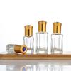 Botella de cuentas octogonales en stock, botella de aceite de vidrio transparente, botellas cosméticas portátiles, botellas vacías para líquido crudo, botella de cuentas