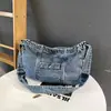 Bolso de hombro nuevo de gran capacidad 2026, versátil para el trabajo, adecuado para que los estudiantes lo usen en clase, bolso vaquero retro estilo coreano para mujer