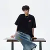 Camiseta Masculina Casual Esportiva Solta Estilo Americano de Verão com Estampa de Letras de Marca Tendência, Gola Redonda, Manga Curta, Versátil, Top para Casal