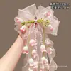 Clip para el pelo rosa con lazo de perlas y flor de lirio del valle para mujer, nuevo accesorio para el pelo medio recogido 2026