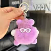 Lindo colgante de bolsa de bola de carbón pequeña de piel de conejo Rex, mochila escolar, muñeco feo, llavero de coche de muñeca de dibujos animados.