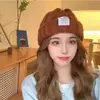 Gorro de lana popular para mujer, invierno 2023, nuevo gorro de punto cálido de moda para mujer, orejeras, gorro frío, moda