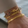 Pulsera Elegante y Silenciosa de Estilo Clásico, Acero Inoxidable 18K Color Bloqueado Hebilla Nudo Ot, Joyería Transfronteriza de Lujo Ligero para Mujer con un Toque de Alta Gama