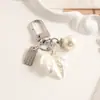 Chaveiro Flor de Pérola Imitação Cruzada Laço Franja de Pérola Pingente de Carro Chaveiro Feminino Pingente de Bolsa
