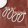 Nueva pulsera creativa de perlas con bonito colgante de aleación de corazón, llavero con cabeza de belleza, accesorios de metal, bolso de joyería para mujer