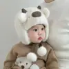 Bonitos y adorables gorros de otoño e invierno para niños, con diseño de poner, material de punto y una serie de dibujos animados, que brindan abrigo y protección para los oídos para bebés y niños pequeños.