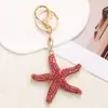 Llavero de Metal Serie Océano Exquisito Llavero de Estrella de Mar con Diamantes Colgante para Coche Colgante de Cadena Conmemorativo de Viaje