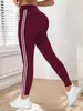 Pantalones de yoga de estilo europeo y americano con rayas laterales de cintura alta para mujer, leggings deportivos finos de primavera/verano para correr, adecuados para uso en exteriores, leggings ajustados de nueve puntos.