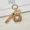Llavero de Audífonos con Pedrería de Cristal Llavero Musical Completamente Cubierto de Pedrería Adorno Colgante de Cuerda de Diamante para Bolso Accesorios Llavero de Coche