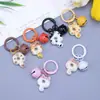 Clip de resorte Campanita Llavero de Gato Dibujo animado lindo Gato Donut Mochila Funda para auriculares Colgante de moda versátil