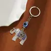 Chaveiro de animal fofo com incrustação de diamantes estilo étnico retrô pingente de mochila para celular olhos azuis pingente de carro