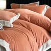 2026 nuevo juego de ropa de cama de alta gama de cuatro piezas de vellón de coral cálido de invierno, sábana y funda de edredón de franela de leche