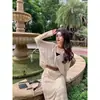 Nuevo conjunto de dos piezas para mujer de verano: suéter de punto hueco, camisa de aire acondicionado, top, cárdigan, chaqueta y falda para mujer