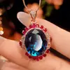 2026 Joyería de Alta Venta Cruzada Chapada en Cobre Dorado Corindón Rojo Simulado Espinela Azul Set de Lujo Ligero Piedra Principal 15*18