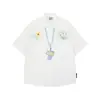 Camisa Listrada de Manga Curta com Estampa Graffiti Estilo Americano 2026 Nova Solta Estilo Coreano Estilo Preguiçoso Camisa Top