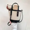 Bolso cubeta de colores contrastantes popular de este año para mujer 2026 nuevo bolso de mano de moda nicho bolso de hombro sensación de alta gama bolso cruzado
