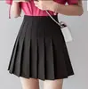 Saia plissada de cintura alta em estoque, saia curta feminina, saia de outono, estilo preppy, versão coreana, cor sólida, saia evasê anti-exposição, atacado