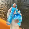 Llavero creativo de concha pequeña con aceite, lindo colgante pequeño de arena movediza líquida, accesorios para bolso, pequeño colgante de regalo, venta al por mayor