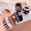Explosiones de otoño e invierno coreanas anillo para toalla de rayas blancas y negras con cara sonriente anillo para el pelo de niños al por mayor pelo grueso pelo suave accesorios para el pelo