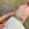 Pulseira de Moda Imitação Jade Hetian Anel Duplo Pingente Fivela Ping An Cordão de Mão Tecido à Mão Pulseira Elegante e Sofisticada Feminina