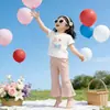 Ropa Infantil Coreana 2026 Verano Nuevo Estilo Tops de Manga Corta para Niñas y Pantalones de Campana Color Sólido Elástico Casual Dulce Conjunto de Dos Piezas