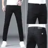 Calça jeans branca de alta qualidade de Hong Kong para homens, corte reto slim, novo estilo de seda gelada para o outono de 2026, adequada para uso profissional