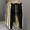 Nueva colección de primavera y otoño: pantalones casuales a rayas de bloques de color para hombre, modernos y elegantes, de pierna recta de alta gama, corte ajustado y deportivos largos