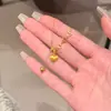 Collar con Borla de Corazón Hueco Cepillado Dorado para Mujer, Cadena para Clavícula con Colgante Minimalista de Estilo Chino Nuevo de Gama Alta de Nicho de Lujo Ligero
